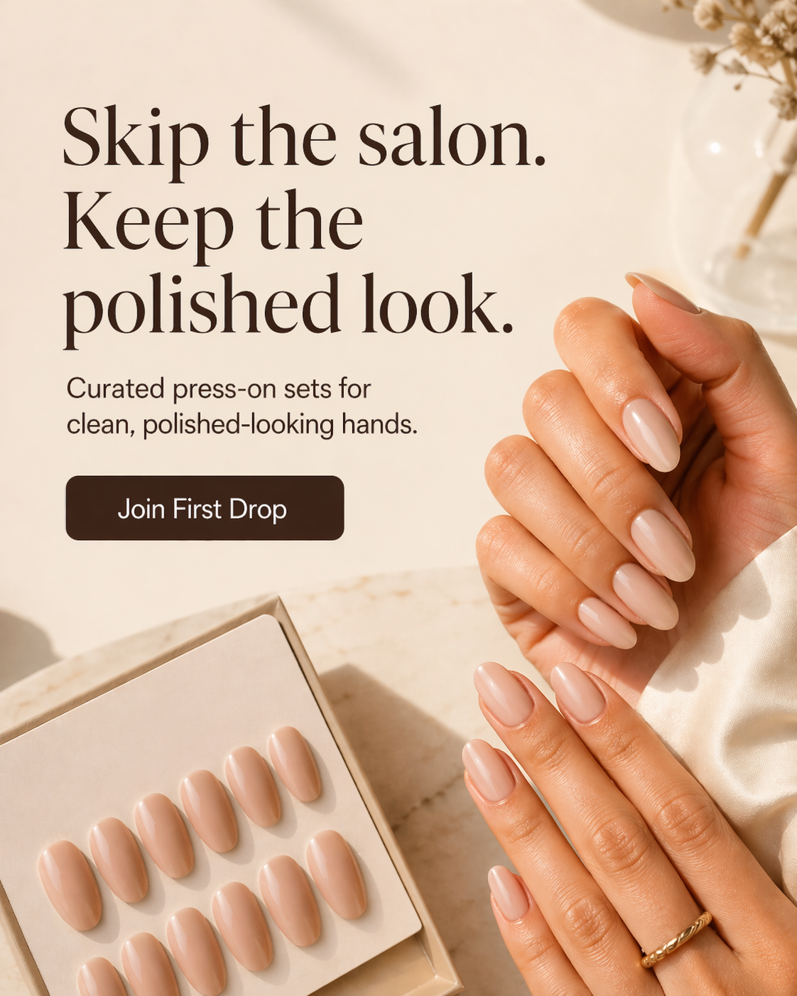 Neutral press-on nails on hands beside a tray, with warm editorial styling