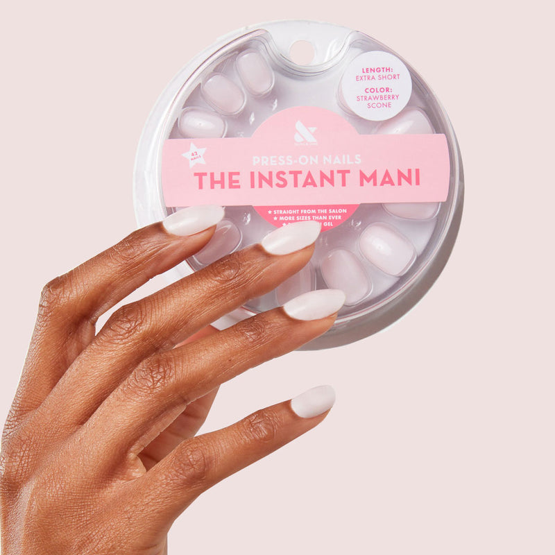 Press-on manicure shown with the product in a soft premium beauty close crop